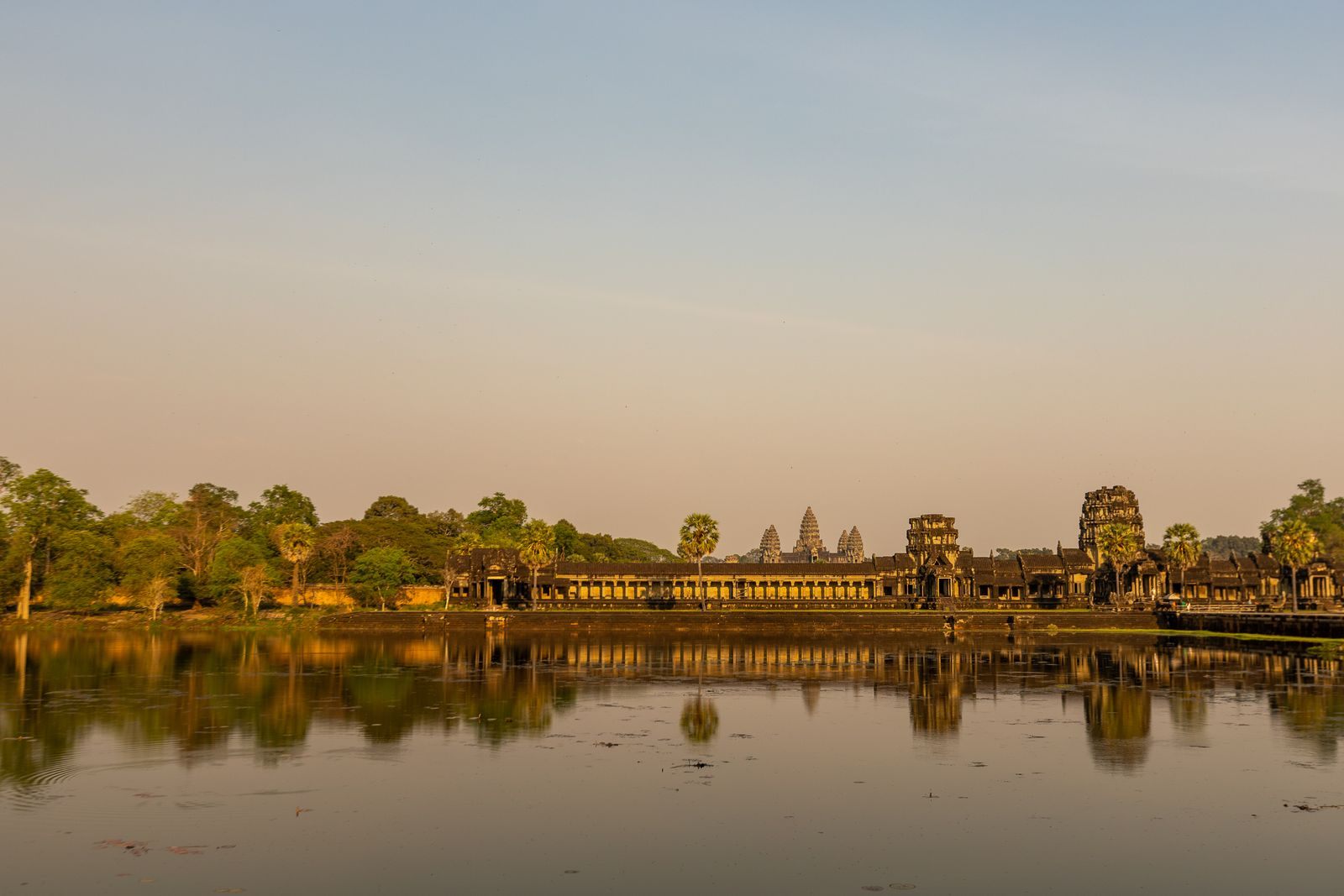 Angkor Wat at sunrise reflected in the pond in front of the temple near Siem Reap, the goal of a Cambodia river cruise to Siem Reap